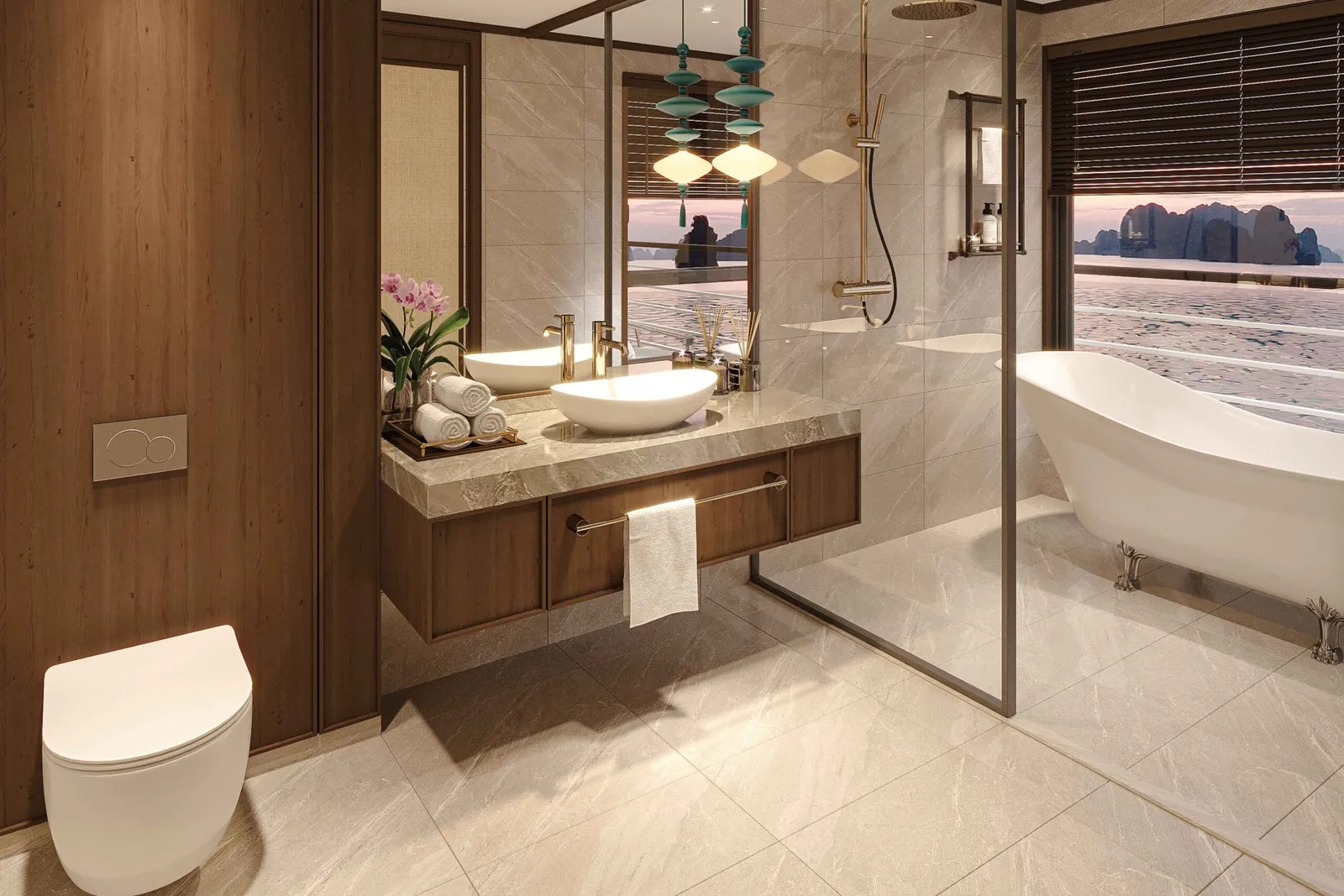 A luxury bathroom with marble finishes, a freestanding tub, and large windows showing karst limestone formations typical of Ha Long Bay at sunset.