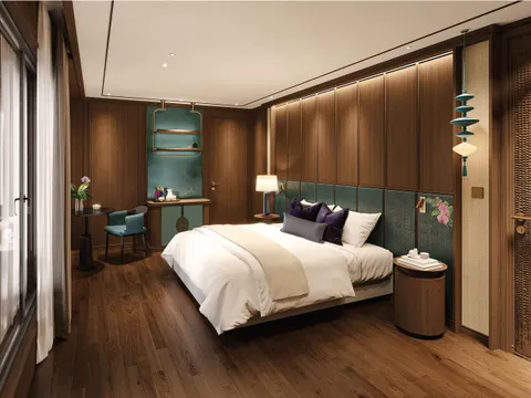 A luxury cabin interior with a double bed, wood paneling, teal accents, and windows on the left side.