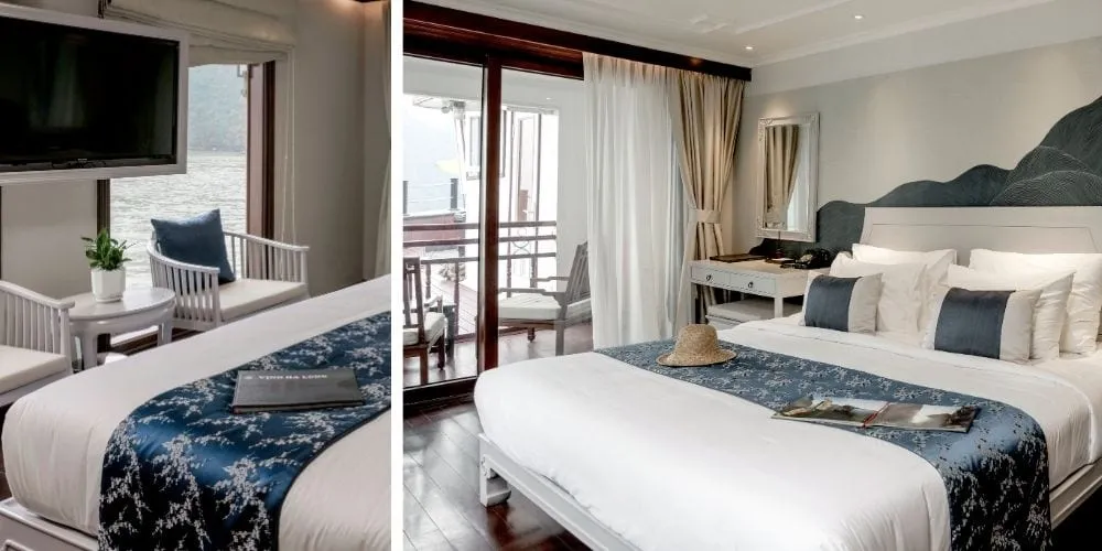 Two side-by-side views of an elegantly furnished cruise cabin with a double bed dressed in blue and white linen, a wall-mounted TV, balcony doors opening onto a water view with karst limestone scenery, and a booklet on the bed reading 'VINH HA LONG'.