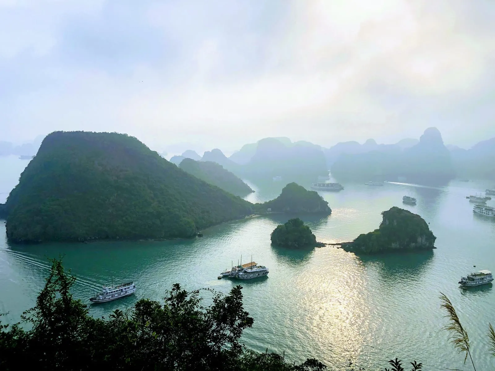 Limestone islands and anchored boats seen from the viewpoint on Titop Island
