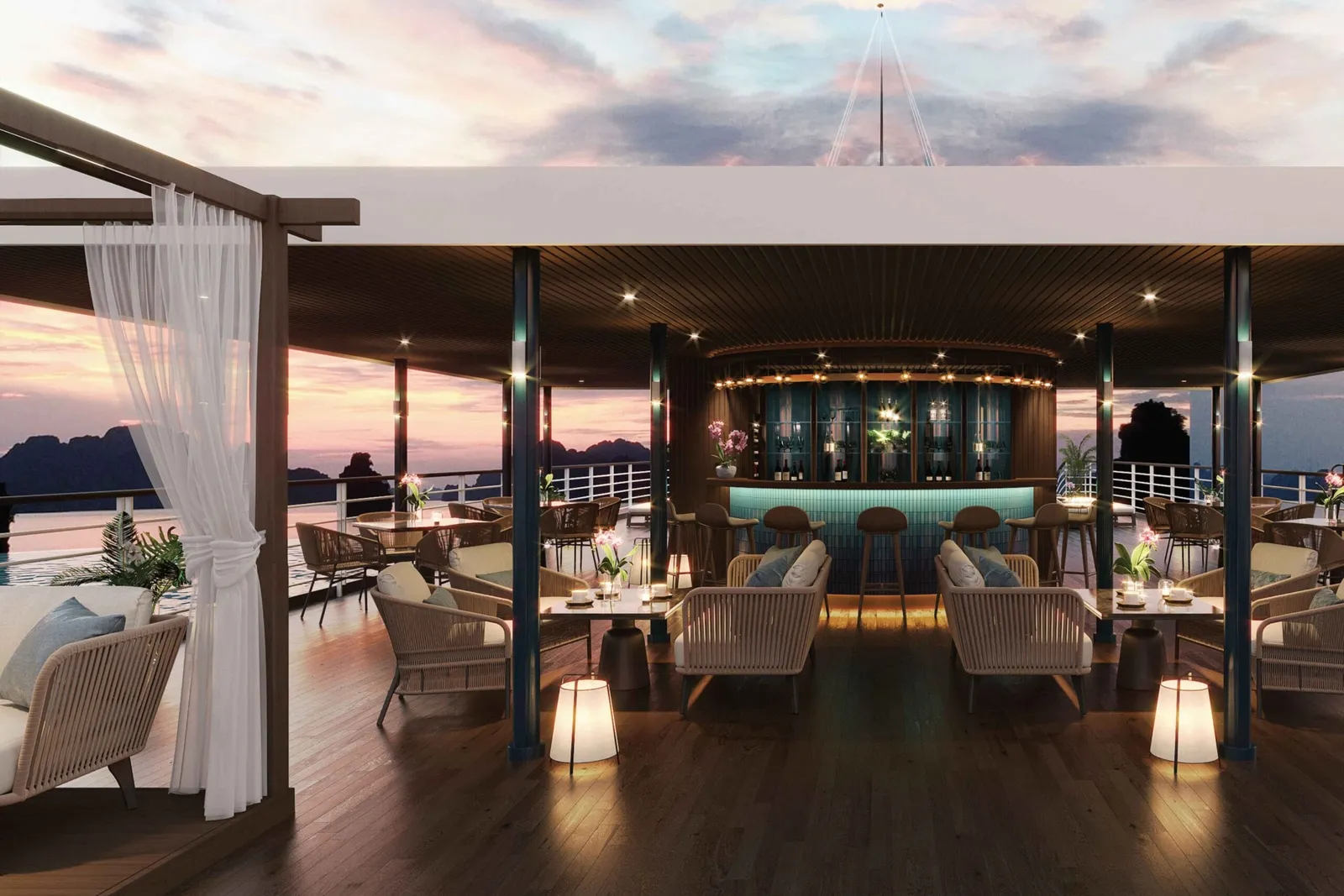 A sunset-lit cruise boat deck with a bar, lounge seating, and dramatic karst islands visible through open sides.