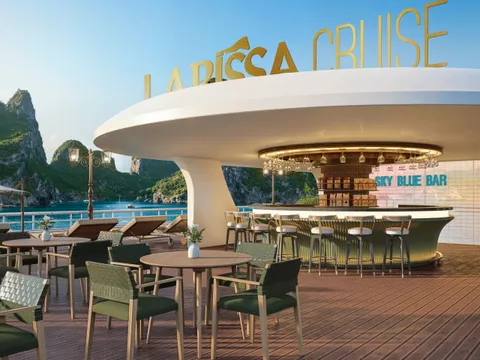 A wooden deck on a cruise boat with outdoor seating, a bar called Sky Blue Bar, large golden letters spelling LARISSA CRUISE mounted on the boat's structure, and dramatic limestone karsts visible in the background water.