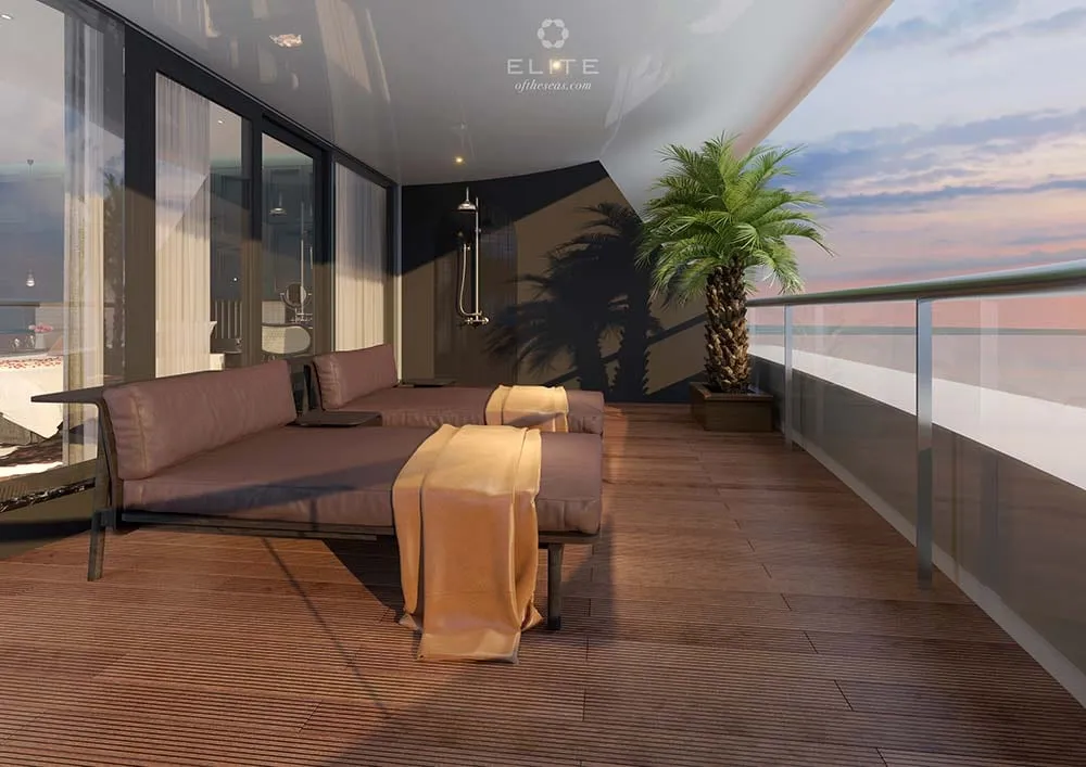 Private balcony with a daybed and a potted palm, an outdoor shower at the far end and the bay beyond the rail