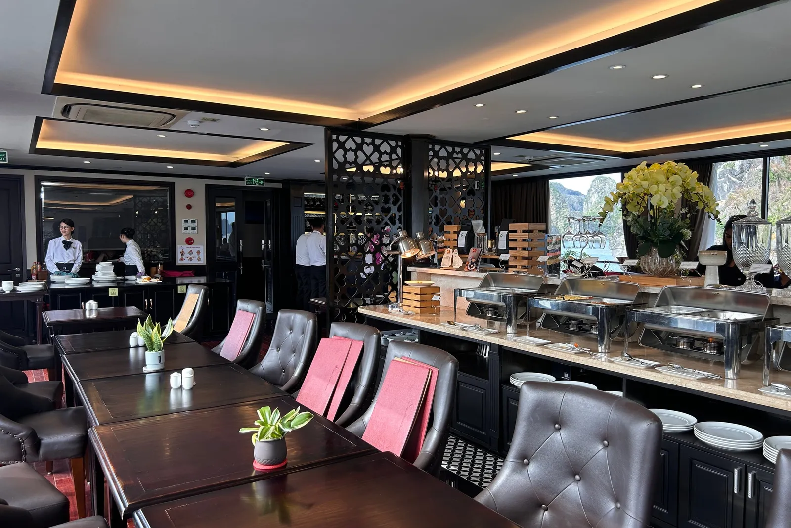 Restaurant with a long table down the middle and the buffet counter set along the far wall