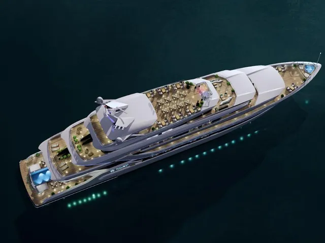 Aerial view of a large white cruise ship with multiple decks, illuminated portholes, and visible dining and pool areas on deck floating in dark teal water.