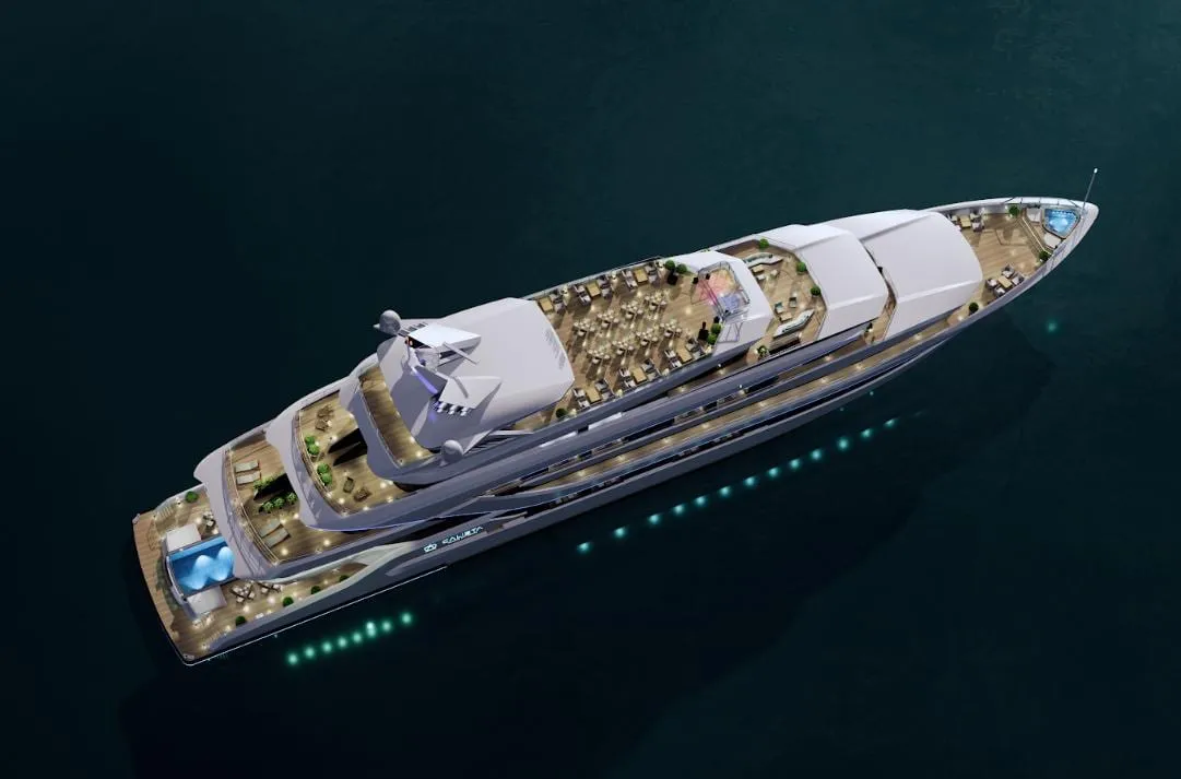 Aerial view of a large white cruise ship with multiple decks, illuminated portholes, and visible dining and pool areas on deck floating in dark teal water.