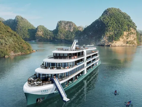 Lyra Grandeur from the air with her waterslide down, moored in a channel between karst islands